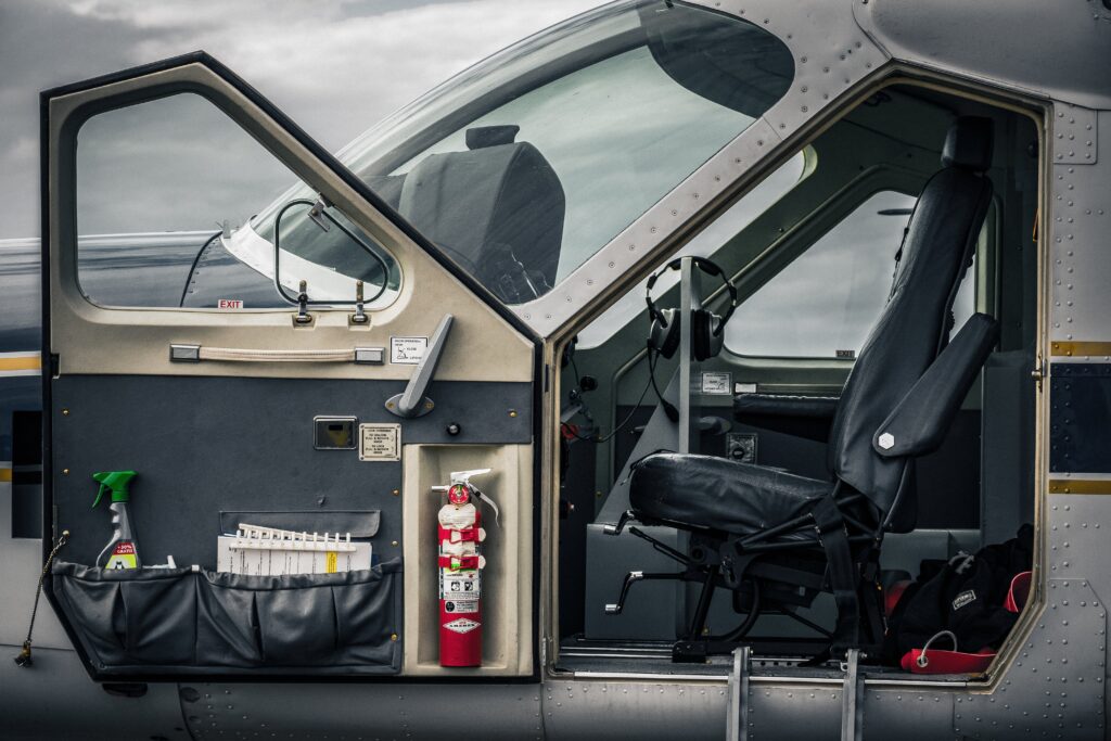 Open door to a Cessna Caravan cockpit. Invitation to try our services in Aircraft Management